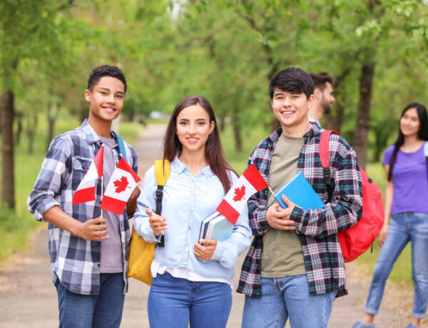 Group of students with Canadian flags outdoors
